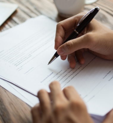 businessman-examining-papers-table